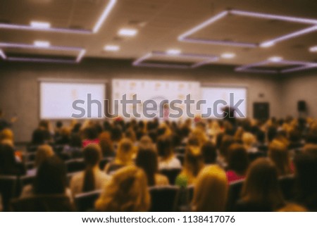 conference. people in the conference room. speech speaker in front of the audience. the audience in the conference room. blurred image / blurred photo. Vintage toning