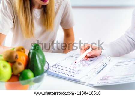 Doctor nutritionist, dietician and female patient on consultation in the office Royalty-Free Stock Photo #1138418510