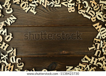 ALPHABET WITH COPY SPACE ON CENTER OVER WOODEN BACKGROUND