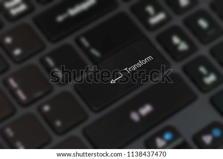 Word 'Transform' isolated on the blurred keyboard buttons background