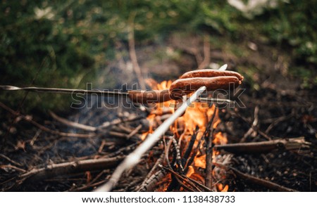 Fried sausages on fire