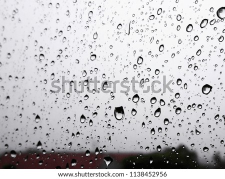 The raindrops fall on the glass as a picture from the top of the building.