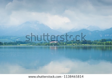 Lake Hopfensee in the Alps of Bavaria on a cloudy day in summer
