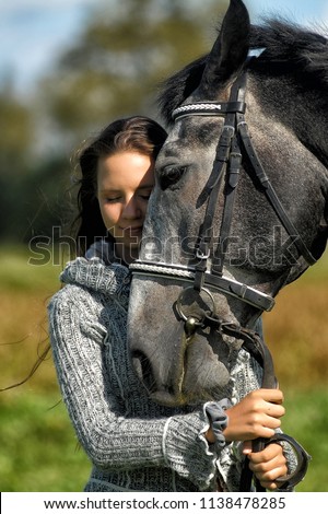 attractive young woman with beautiful white and gray horse camargue