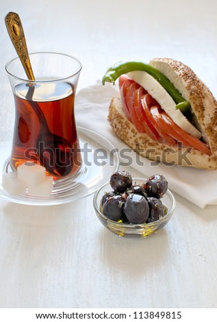 Breakfast with sandwich, tea and black olives