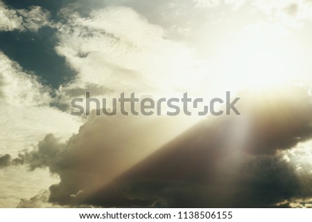 Dramatic apocalyptic clouds background with light rays 