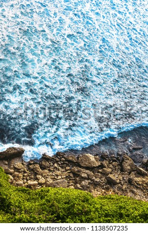 Sea landscape background, water with waves and rock, top view of the ocean, the coastline and the rocky beach. Amazing view, Uluwatu, Bali, Indonesia, Asia. Concept travel. 
