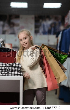 young girls go shopping clothes , buy and measure things shopping