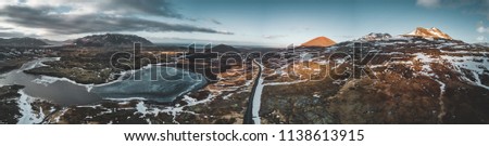 Aerial drone photo of a empty lake and street highway 1 with a huge volcanic mountain Snaefellsjokull in the distance, Reykjavik, Iceland.