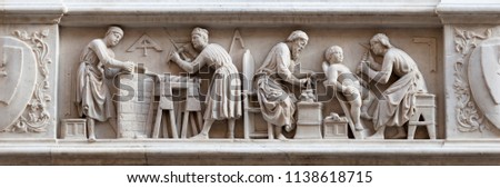 Master stonemasons, woodcarvers, and sculptors, represented in a bas-relief (1408) on the external facade of the Orsanmichele Church, Florence, Italy Royalty-Free Stock Photo #1138618715