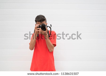Portrait of young man taking a picture