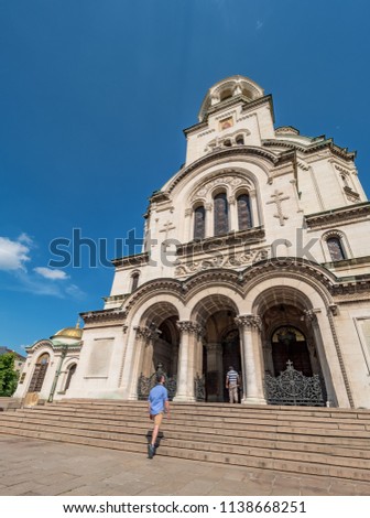 Young caucasian man takes pictures to Alexander Nevsky cathedral in Sofia, Bulgaria. Solo traveler concept.