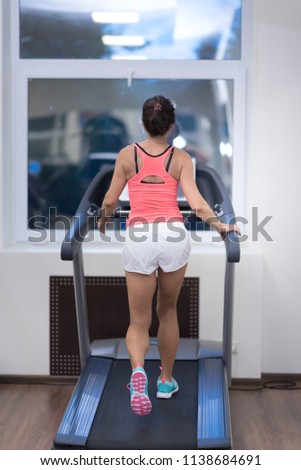 middle age woman running in sports club.