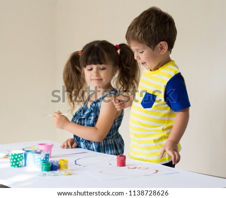 Toddler boy and four years girl having fun together at a daycare. Preschool kids