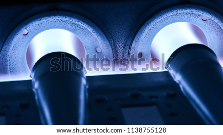 Closeup Shot Of Home Furnace Burner Ignited With Crimson Blue Flame Royalty-Free Stock Photo #1138755128
