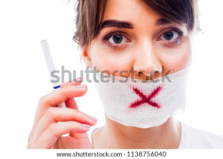 A girl with a mouth tied and a cigarette in her hands