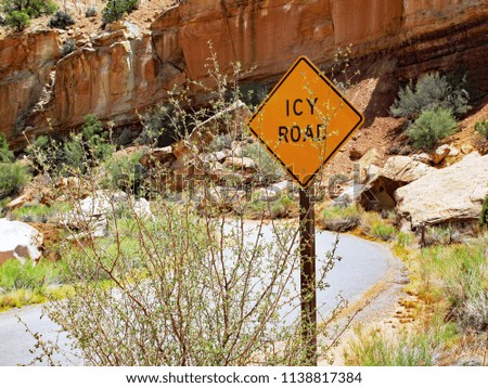 Icy Road Sign Located at the Side of a Small Road in the Desert