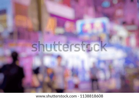 Blurred pictured of night life in the city. People walking and shopping until the shop close.