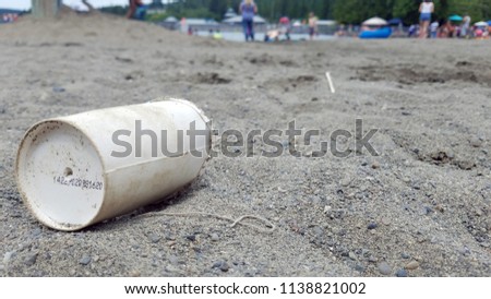 Paper cup got disposed at beach where children are playing