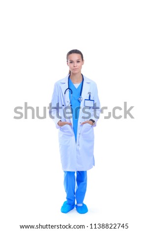 Beautiful young woman in white coat posing with hand in pocket. Woman doctor