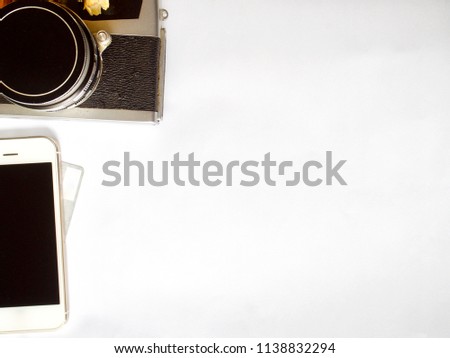 Film camera, smartphone over credit card on white background
