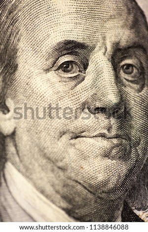 Portrait of Ben Franklin on the US $100 dollar bill in macro. Macro close up of Ben Franklin's face on the US $100 dollar bill. 
