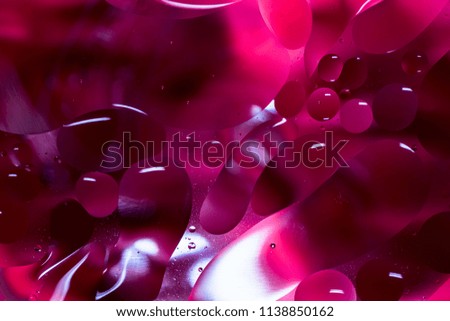 A beautiful water and oil art with color paper in the background in macro life size. It creates beautiful abstracts shapes for background use