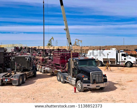 Fracking, well head connected to fracking pumps. Royalty-Free Stock Photo #1138852373