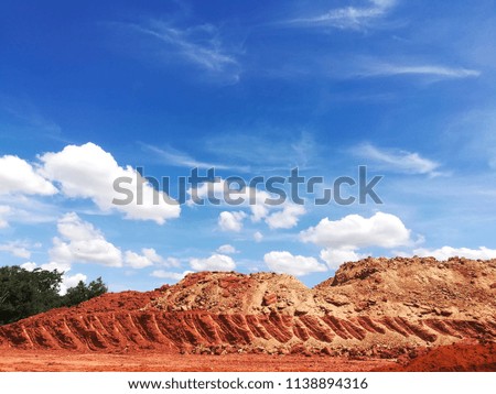The mound was dug to build a road. Sky background.