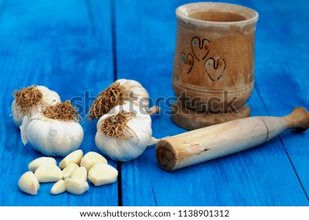 Garlic cloves and bulbs on wooden background