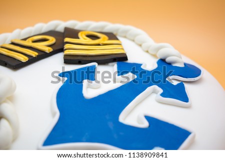 Close Up of a Cake With Navy  Decoration on Blur Orange Background