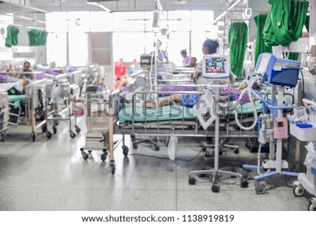 Blurred hospital background with patient on bed  showing quality of healthcare service for treatment.