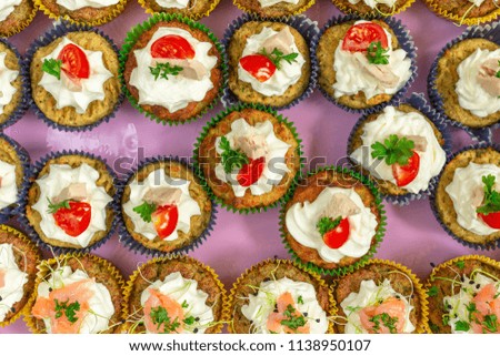 Salted Cupcakes With Cream, Tomato, Tuna And Salmon Fish On The Top. Appetizer Tray Decor.