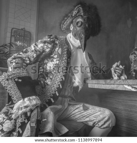 Actor in steam punk masks and antique costumes black-white art photo.