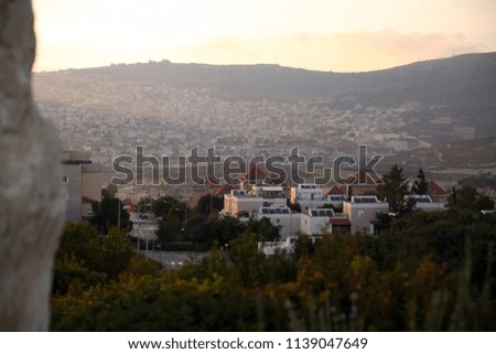 Cliffs of israel. Mountainous terrain of the Mediterranean Sea. Red roofs of residential buildings in the mountains of the Mediterranean. Residential buildings of the city with rocky highlands.