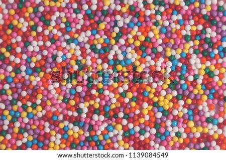 Colorful bright background of small balls for screen saver for designer. Multicolored painted grains. Ball Pool Pattern