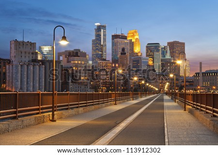 Minneapolis. Image of Minneapolis skyline taken from Stone Arch Bridge at sunset .