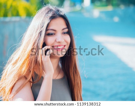 Female speaking on her cellphone. Technology, smartphone concept. Woman have conversation with friend. Talking and smiling girl with oriental face.