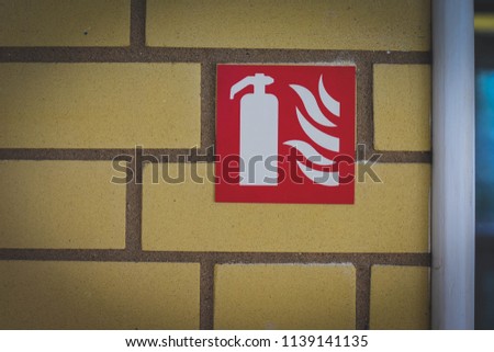 Fire Extinguisher Symbol on a Wall