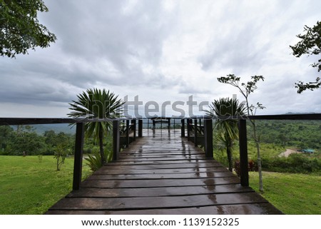 Wood bridge observation deck in national park with cloudy sky ,Kanchanaburi,Thailand
