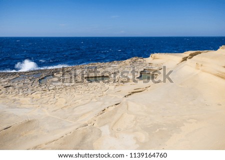 Waves Crashing on Gozo Natural Salines with Mediterranean Sea in the Background