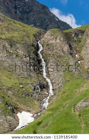 Waterfall in the Alps. Gressoney Valley is situated in the Aosta Valley, in northern Italy. It is marked by Lys river whose source is the glacier of Monte Rosa.