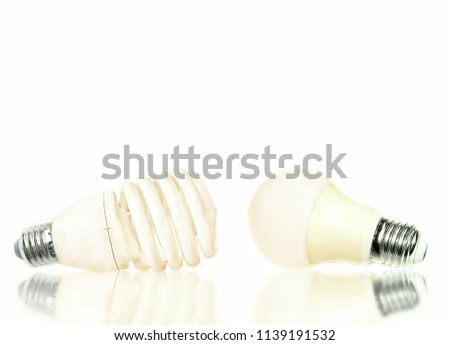 2 shapes of LED energy saving lamp with blurred reflection on isolated white background, close up shot with copy space 