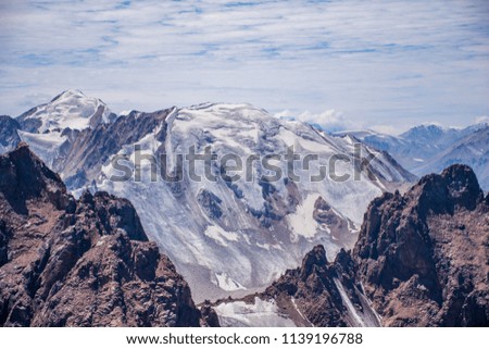 The random mountain with rocks and ice in Tian Shan mountains in Central Asia near Almaty covered by clouds.
Best place for active life, hiking and trekking in Kazakhstan. 