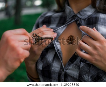 Ternopil, Ukraine - June 2018. The human soul opens the key, girl hand open the shirt.