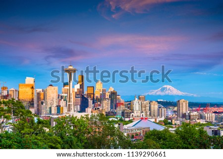 Seattle, Washington, USA downtown skyline at night with Mt. Rainier.