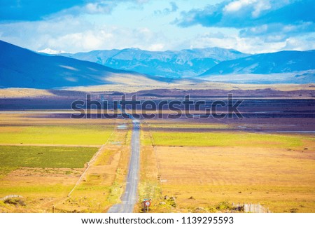 The highway crosses Patagonia and leads to the tops of the mountains, Chile. Copy space for text