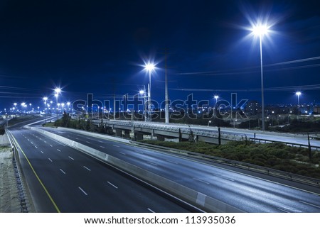 Empty freeway at night Royalty-Free Stock Photo #113935036