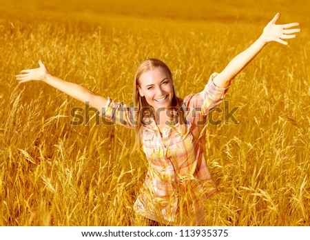 Picture of happy cheerful girl having fun on wheat field, beautiful blond woman with raised up hands enjoying freedom outdoors, agriculture lifestyle, autumn harvest concept, fall season