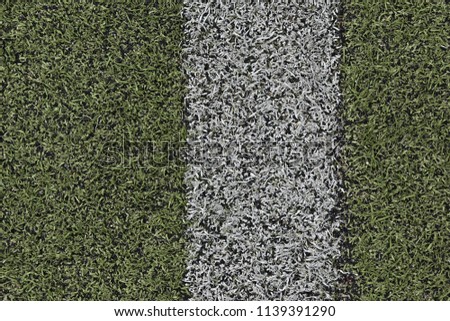 Stadium coverage for football fields. For running sports. Strongly worn, trampled, faded artificial material. Surface requiring replacement, repair
